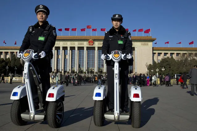 Chinese police officers patrol on motorized platforms near the Great Hall of the People where a plenary session of the National People's Congress is held in Beijing, China, Sunday, March 12, 2017. China's chief justice said Sunday during his work report to the Congress that his country, which is believed to execute more people than the rest of the world combined, gave the death penalty “to an extremely small number of criminals for extremely serious offenses” in the past 10 years. (Photo by Ng Han Guan/AP Photo)