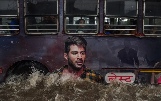 A public bus makes its way on a flooded road after heavy monsoon rains in Mumbai, India on August 4, 2019. (Photo by Indranil Mukherjee/AFP Photo)