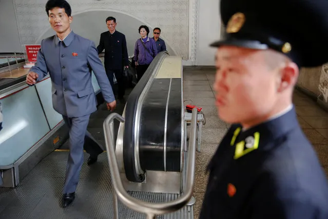 A subway worker stands at the end of escalators as passengers leave the subway station visited by foreign reporters on a government organised tour in central Pyongyang, North Korea May 7, 2016. (Photo by Damir Sagolj/Reuters)