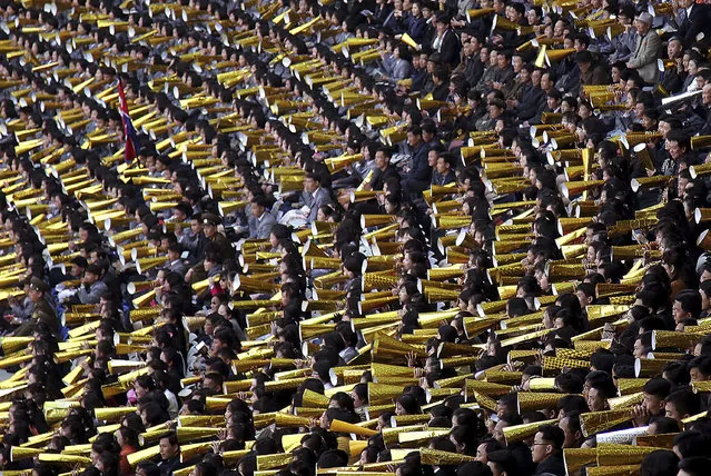 North Koreans cheer as their country's women's soccer team competes against South Korea in a qualifying soccer match for the Asian Football Confederation Cup at the Kim Il Sung Stadium on Friday, April 7, 2017, in Pyongyang, North Korea. (Photo by Jon Chol Jin/AP Photo)