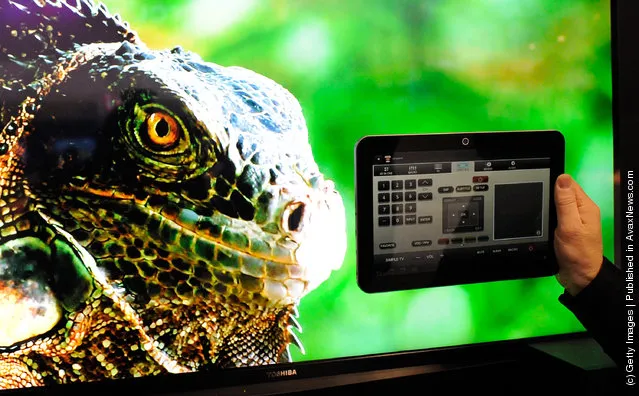 A Toshiba Excite EX10 Android tablet running the Tablet Remote App Capable (TRAC) technology is displayed in front of a Toshiba 55-inch L7200 Series TV at the 2012 International Consumer Electronics Show