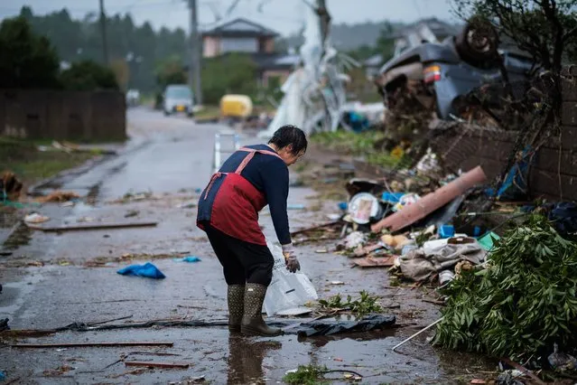A lady tries to clean as she can in front of her destroyed house by strong tornado in Ichihara near Tokyo on October 12, 2019, ahead of the arrival of Typhoon Hagibis, which is expected to make landfall in eastern Japan later in the day. (Photo by Nicolas Datiche/SIPA Press)