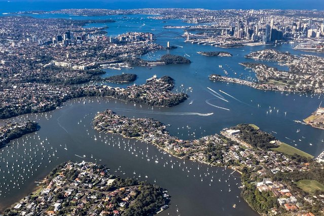 A photo taken on June 16, 2024 shows an aerial view of boats on Sydney Harbour, with the Sydney Harbour Bridge and buildings in the central business district (CBD). (Photo by David Gray/AFP Photo)