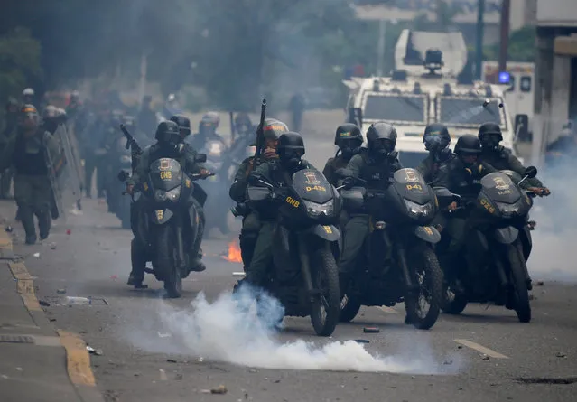 Riot police take position while clashing with opposition supporters rallying against President Nicolas Maduro in Caracas, Venezuela, May 3, 2017. (Photo by Carlos Garcia Rawlins/Reuters)