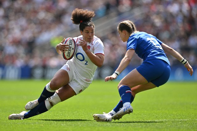 England's centre Tatyana Heard (L) runs with the ball next to France's centre Marine Menager during the Six Nations international women's rugby union match between England and France at Twickenham in south-west London on April 29, 2023. (Photo by Glyn Kirk/AFP Photo)