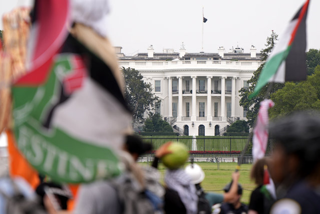 Demonstrators pass the White House during a protest against the visit of Israeli Prime Minister Benjamin Netanyahu to the White House, Thursday, July 25, 2024, in Washington. (Photo by Mike Stewart/AP Photo)