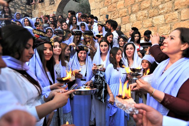 Iraqi Yazidis visit the Lalish Temple, on the day of a ceremony for the occasion of Red Wednesday, the celebration of the Yazidi New Year, in Shekhan district, in Duhok province, Iraq on April 18, 2023. (Photo by Ari Jalal/Reuters)