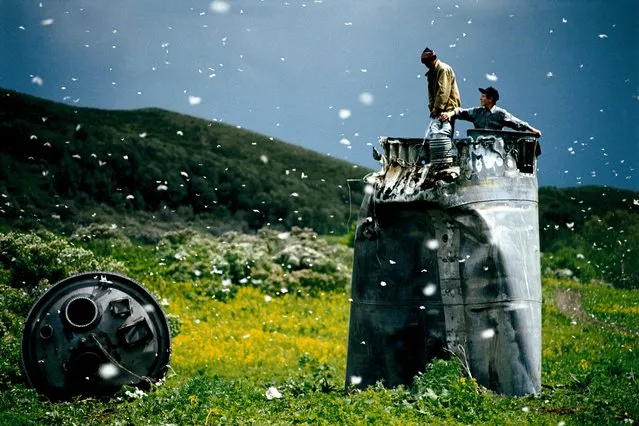 Villagers collecting scrap from a crashed spacecraft, surrounded by thousands of white butterflies in the Altai Territory, Russia, in 2000. Environmentalists fear for the region's future due to the toxic rocket fuel. (Photo by Jonas Bendiksen/Magnum Photos)