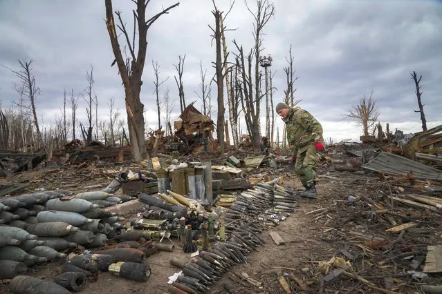 An interior ministry sapper collects unexploded shells, grenades and other devices in Hostomel, close to Kyiv, Ukraine, Monday, April 18, 2022. (Photo by Efrem Lukatsky/AP Photo)