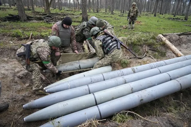 Ukrainian soldiers collect multiple Russian “Uragan” missiles after recent fights in the village of Berezivka, Ukraine, Thursday, April 21, 202. (Photo by Efrem Lukatsky/AP Photo)