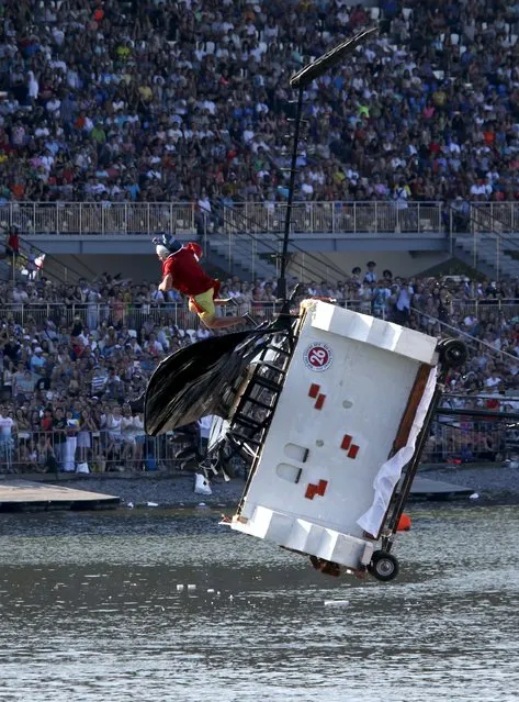 A participant falls down during the Red Bull Flugtag Russia 2015 competition in Moscow, Russia, July 26, 2015. (Photo by Sergei Karpukhin/Reuters)