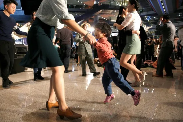 People dance at a Retro Swing Night event in a shopping mall in Beijing, China on December 6, 2019. (Photo by Jason Lee/Reuters)