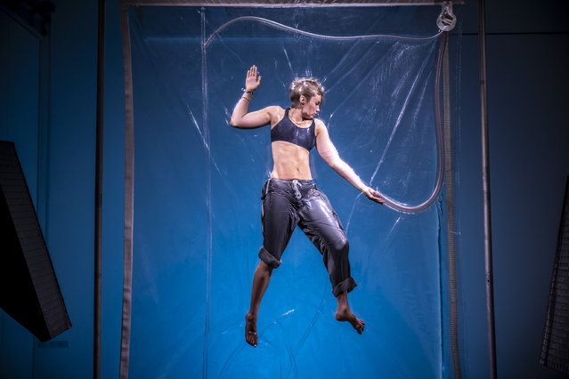 Isadora Falstaff, 17, is vacuum-packed and vertically suspended between two transparent plastic sheets as a part of Shrink 01995, a performance artwork by Lawrence Malstaf on display at the Great North Museum in Newcastle, UK on August 8, 2024. (Photo by James Gloss/The Times)