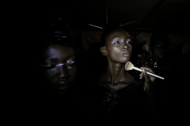 A model has her make up done backstage during Dakar Fashion Week in the Senegalese capital, Friday June 30, 2017. (Photo by Finbarr O'Reilly/AP Photo)