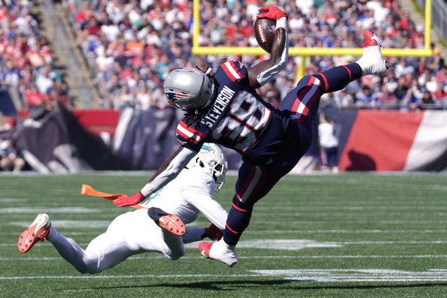 New England Patriots running back Rhamondre Stevenson (38/AP hangs onto the ball after colliding with Miami Dolphins cornerback Kader Kohou (4/AP during the first half of an NFL football game, Sunday, October 6, 2024, in Foxborough, Mass. (Photo by Steven Senne/AP Photo)