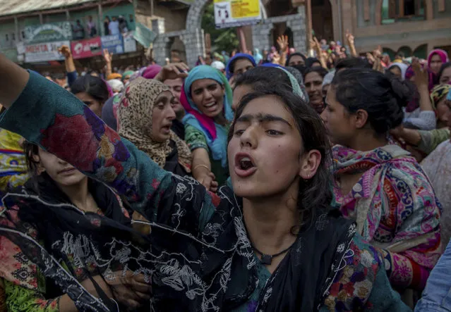 A Kashmiri village girl shouts pro-freedom slogans during the funeral procession of a civilian Tanveer Ahmed Wani in Beerwah about 40 kilometers (25 miles) west of Srinagar, Indian controlled Kashmir, Friday, July 21, 2017. (Photo by Dar Yasin/AP Photo)