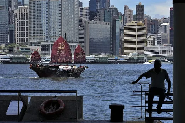 A Chinese junk sails across Victoria Harbor to celebrate the 25th anniversary of Hong Kong handover to China, in Hong Kong, Monday, June 27, 2022. (Photo by Kin Cheung/AP Photo)