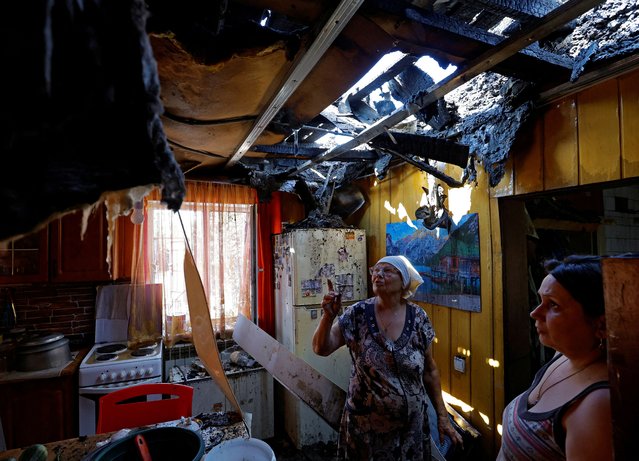 Local resident Olga Paramonova, 49, and her mother Natalia look at the destroyed roof of their house damaged by recent shelling in the course of Russia-Ukraine conflict in Donetsk, Russian-controlled Ukraine on August 8, 2023. (Photo by Alexander Ermochenko/Reuters)