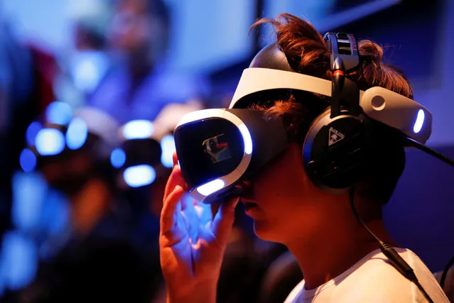 A gamer wears virtual reality (VR) goggles at the world's largest computer games fair, Gamescom, in Cologne, Germany August 23, 2017. (Photo by Wolfgang Rattay/Reuters)