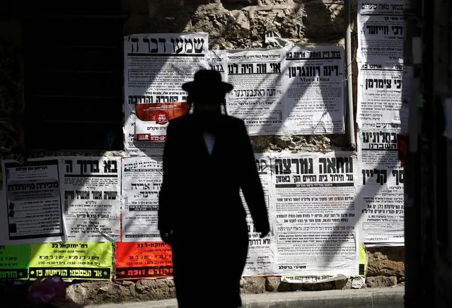 A picture taken on September 13, 2017, shows an Ultra-Orthodox Jew walking in the Ultra-Orthodox neighborhood of Mea Shearim of Jerusalem. Israel's Supreme Court struck down a law on September 13, 2017 which previously exempted ultra-Orthodox men engaged in religious study from military service like their secular counterparts, saying it undermines equality and raising the possibility that they could be forced into service. The court however suspended its decision for one year to allow for preparations for the new arrangement – which also provides the government with the opportunity to pass a new law. (Photo by Thomas Coex/AFP Photo)