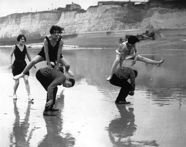 Members of the Brighton Swimming Club leap-frogging on the beach at Brighton, 1925. (Photo by E. Bacon)