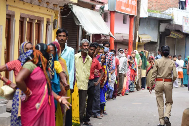 People don't follow social distance as they are in queue to take free grocery at Daraganj area during nationwide lockdown in wake of Coronavirus in Prayagraj on Wednesday, April 08, 2020. (Photo by Prabhat Kumar Verma/Pacific Press/Rex Features/Shutterstock)