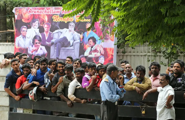 Fans of Indian actor Rajinikanth wait outside a theatre to buy tickets on the eve of release of his new movie Kabali, in Bangalore, India, Thursday, July 21, 2016. Businesses in southern India have given their employees the day off on Friday so they can attend screenings of a new film starring Tamil cinema's superstar Rajinikanth. One of Asia's highest paid actors, Rajinikanth is considered one of the most bankable stars in India. (Photo by Aijaz Rahi/AP Photo)