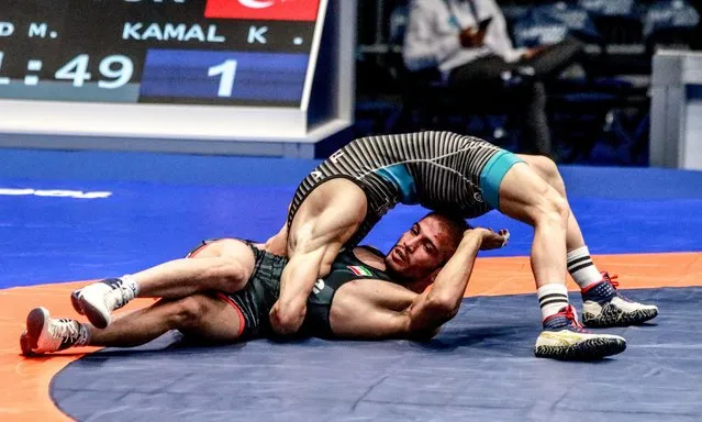 Kerem Kamal (blue) of Turkiye in action against Mehdi Seifollah Mohsen Nejad (red) of Iran during the third day of the World Wrestling Championship in Belgrade, Serbia on September 12, 2022. (Photo by Filip Stevanovic/Anadolu Agency via Getty Images)