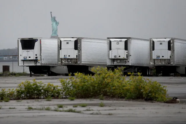 Refrigerated trucks functioning as temporary morgues are seen at the South Brooklyn Marine Terminal on May 06, 2020 in the Brooklyn borough of New York City. New York City's Medical Examiner are now operating a long-term disaster morgue at Brooklyn's 39th Street Pier, where human remains will be kept inside freezer trucks, in an effort to provide relief to funeral directors overwhelmed from the COVID-19 crisis. (Photo by Justin Heiman/Getty Images)