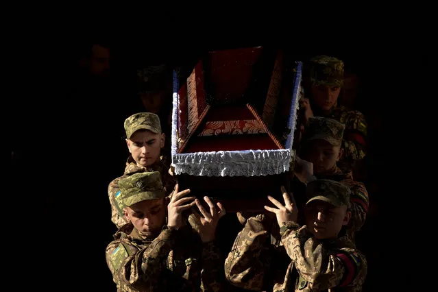 Ukrainian servicemen carry a coffin during a funeral ceremony for their brothers-in-arms Yurii Leliavskyi, Roman Vyshynskyi and Ihor Hadiak, who were recently killed while fighting against Russian troops, amid Russia's attack on Ukraine, in Lviv, Ukraine on October 7, 2022. (Photo by Pavlo Palamarchuk/Reuters)