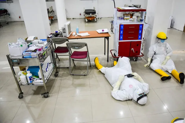Medical staff wearing protective suits take a rest at an emergency room amid the coronavirus disease (COVID-19) outbreak in Pekanbaru, Riau Province, Indonesia, June 5, 2020. (Photo by F.B. Anggoro/Antara Foto via Reuters)