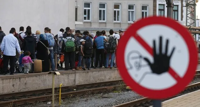 Migrants queue on the platform, waiting for a train at Vienna west railway station, Austria September 13, 2015. (Photo by Heinz-Peter Bader/Reuters)