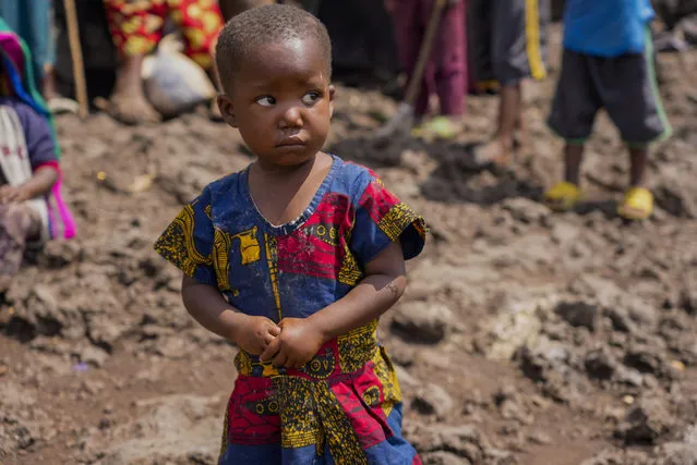 Pasika Bagerimana's daughter Mahigwe stands outside a temporary shelter she shares with others who fled fighting, in Nyiragongo, Democratic Republic of Congo, August 31, 2022. Bagerimana, who lost two children to hunger, worries her remaining two children might be next. “Hunger is killing people”, she says. Hunger is soaring across parts of Congo's war-torn North Kivu province where the fighting between M23 rebels and government soldiers has been raging since March, according to aid workers, civilians and health workers. (Photo by Sam Mednick/AP Photo)