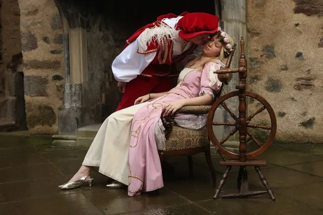 HOFGEISMAR, GERMANY - NOVEMBER 18:  Prince Charming, actually actor Andreas Richhardt, kisses Sleeping Beauty, played by actress Elisabeth Knoche, to wake her from her 100-year sleep at Sababurg Palace on November 18, 2012 near Hofgeismar, Germany. Sleeping Beauty (in German: Dornroeschen) is one of the many stories featured in the collection of fairy tales collected by the Grimm brothers, and the 200th anniversary of the first publication of the stories will take place this coming December 20th. Andreas and Elisabeth perform a skit based on the Sleeping Beauty tale to visitors during the summer months at Sababurg, which is now a hotel called Dornroeschenschloss Sababurg and is located along the “Fairy Tale Road” (“Maerchenstrasse”) from where many of the tales derive. The Grimm brothers collected their stories from oral traditions in the region between Frankfurt and Bremen in the early 19th century, and the works include such global classics as Rapunzel, Little Red Riding Hood, The Pied Piper of Hamelin, Cinderella and Hansel and Gretel.  (Photo by Sean Gallup)