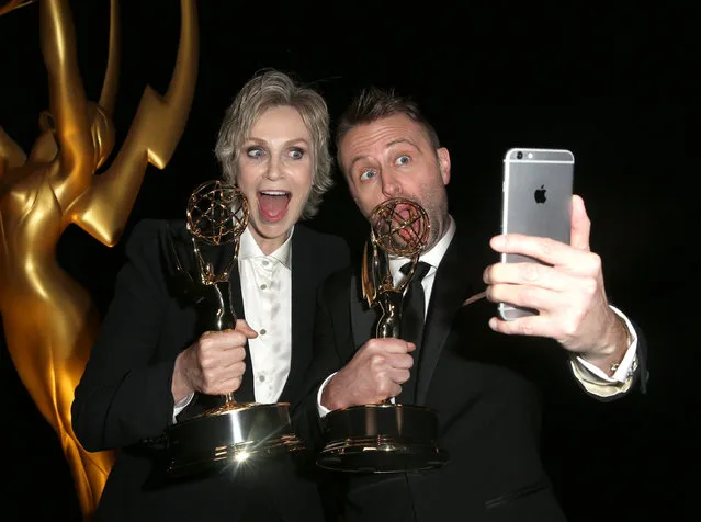 Jane Lynch, left, and Chris Hardwick pose backstage at the Television Academy's Creative Arts Emmy Awards at Microsoft Theater on Saturday, September 12, 2015, in Los Angeles. (Photo by Rich Fury/Invision for the Television Academy/AP Images)