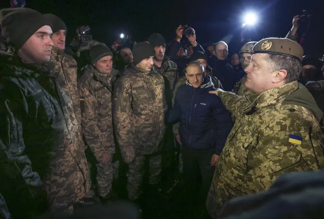Ukrainian President Petro Poroshenko, right, speaks to prisoners who were released by separatists in the town of Kramatorsk, eastern Ukraine, Wednesday, December 27, 2017. Ukrainian authorities and separatist rebels in the country's east have conducted a massive exchange of prisoners, the largest ever trade of captives since the start of the conflict. (Photo by Mikhail Palinchak/Presidential Press Service Pool Photo via AP Photo)