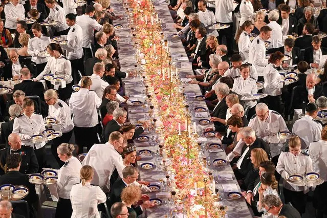 Waiters serve the dessert during the royal banquet in honour of the laureates of the Nobel Prize 2022, following the Award ceremony on December 10, 2022 in Stockholm. (Photo by Jonathan Nackstrand/AFP Photo)
