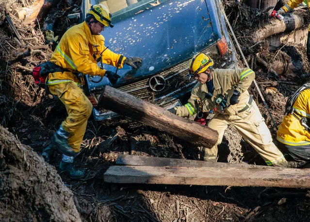 Rescue workers scour through cars for missing persons after a mudslide in Montecito, California, U.S. January 12, 2018. (Photo by Kyle Grillot/Reuters)