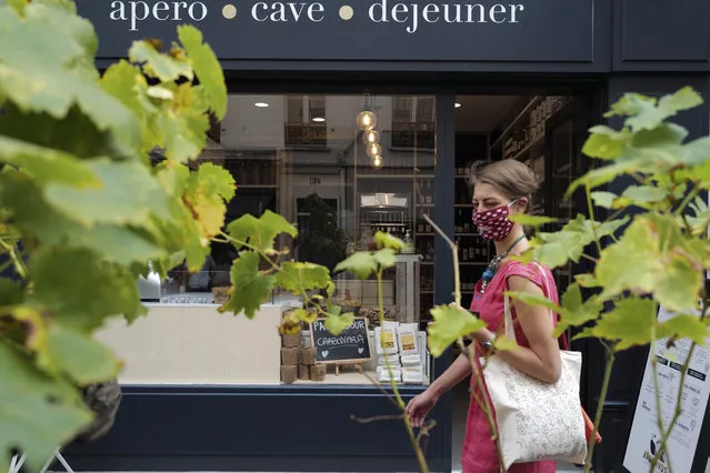 A woman, wearing a protective face mask as a precaution against the coronavirus, walks in Paris, Friday, September 11, 2020. French health authorities have reported on Thursday 9,843 infections from the coronavirus in 24 hours, the highest daily tally since the end of France's lockdown in April. France has seen a sharp uptick in new cases in recent weeks and hospitalizations have started to increase steadily, reaching now over 5,000 including 615 people in ICU. (Photo by Francois Mori/AP Photo)