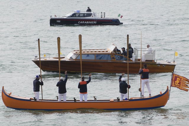 Pope Francis is greeted by Gondoliers upon his arrival in Venice, Italy, Sunday, April 28, 2024. The Pontiff arrived for his first-ever visit to the lagoon town including the Vatican pavilion at the 60th Biennal of Arts. (Photo by Alessandra Tarantino/AP Photo)