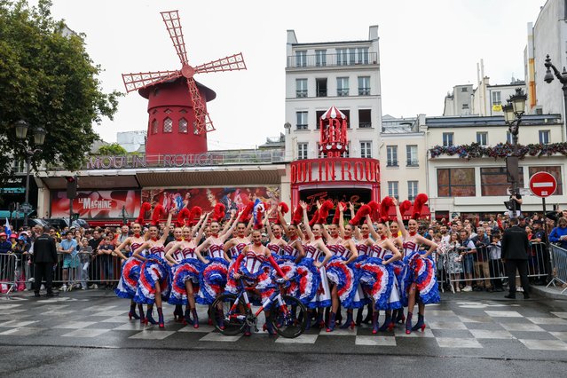 Dancers perform French Cancan in front of the Moulin Rouge to cheers the cyclists during the final stage of Tour de France at Le Moulin Rouge on July 27, 2025 in Paris, France. (Photo by Pierre Suu/Getty Images)