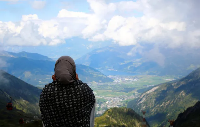 An Arab tourist looks down from Kitzsteinhorn mountain near Zell am See, Austria, August 30, 2016. (Photo by Leonhard Foeger/Reuters)