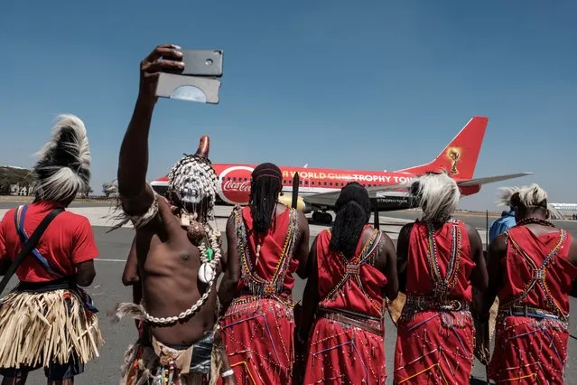 A dancer takes a selfie upon the arrival of the special aircraft carrying the FIFA World Cup Trophy during its World Tour on February 26, 2018 at the Jomo Kenyatta International airport in Nairobi. (Photo by Yasuyoshi Chiba/AFP Photo)
