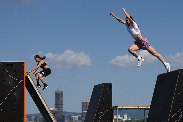 Bulgaria’s Kseniya Momchilova and Argentina’s Sara Banchoff Tzancoff in action during the women’s speed qualification run in the parkour competition at the World Games in Chengdu, China on August 12, 2025. (Photo by Lisi Niesner/Reuters)
