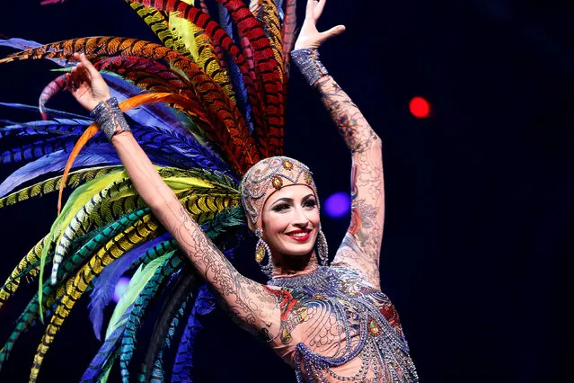 A dancer attends a photocall for the new “THE ONE Grand Show” at Friedrichstadt-Palast in Berlin, Germany, September 28, 2016. From silver body suits with giant mohawks to revealing fishnet tops with huge feathers, colourful, extravagant costumes take centre stage at a new theatrical show in Berlin. French couturier Jean Paul Gaultier has swapped the Paris runway for the German stage to create some 500 costumes for “THE ONE Grand Show”, an 11-million euro ($12.2 million) production showcasing plenty of singing, dancing and acrobatics. Fashion's “enfant terrible”, who designed Madonna's cone brassiere for her 1990 “Blond Ambition” tour, takes on his first revue show, in which an abandoned theatre comes back to life thanks to an underground party. The show, which premiered on Thursday, is scheduled to run at Berlin's Friedrichstadt-Palast until mid-2018. (Photo by Hannibal Hanschke/Reuters)