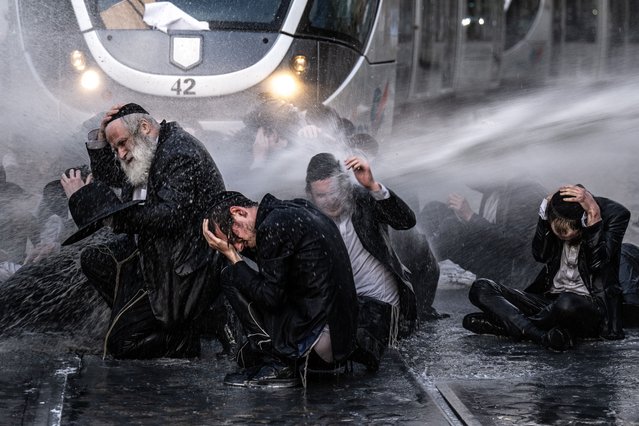 Israeli forces intervene in Ultra-Orthodox Jews who stage a demonstration on tramline to protest the mandatory armed service West Jerusalem on May 23, 2024. (Photo by Mostafa Alkharouf/Anadolu via Getty Images)