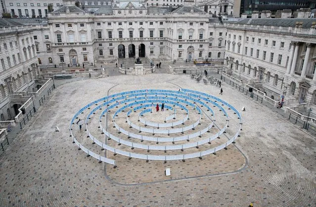 Visitors walk around Whorled (Here After Here After Here), an outdoor installation by Jitish Kallat in Somerset House, London, Britain on February 16, 2023. (Photo by Anna Gordon/Reuters)