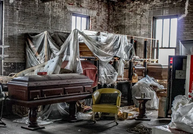 Urban Explorer Abandoned Southeast says, “It is unusual, but that’s what I enjoyed most about it – the amount of things left behind. Old coffins on shelves, glassware used for embalming, early 1900s photographs of people, probably left over from funerals”. (Photo by Abandoned Southeast/Caters News Agency)