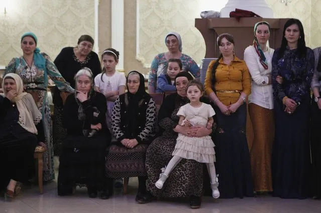 Women watch dancing at a wedding party in the Chechen capital Grozny April 24, 2013