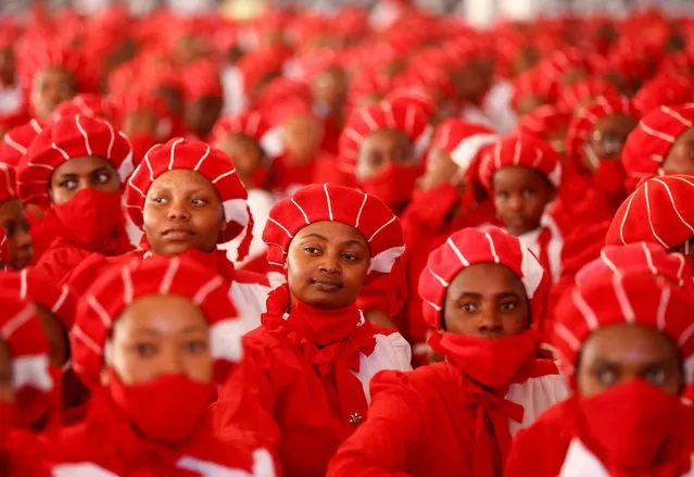 Church members watch the arrival of more than 800 couples taking part in the Easter Sunday mass wedding ceremony, organised by the International Pentecostal Holiness Church Jerusalem City (IPHC), in Kgabalatsane, in the North-West province, South Africa on April 9, 2023. (Photo by Siphiwe Sibeko/Reuters)